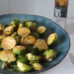 Blue plate of roasted Brussels sprouts
